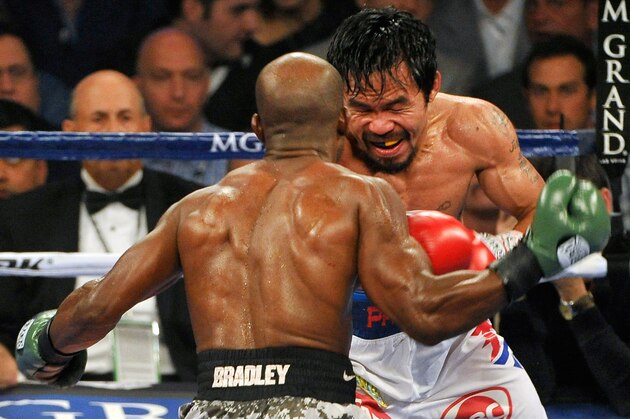 LAS VEGAS, NV - APRIL 12:  Timothy Bradley (L) and Manny Pacquiao battle it out during their WBO world welterweight championship boxing match at the MGM Grand Garden Arena on April 12, 2014 in Las Vegas, Nevada. Pacquiao won by unanimous decision.  (Photo by David Becker/Getty Images)
