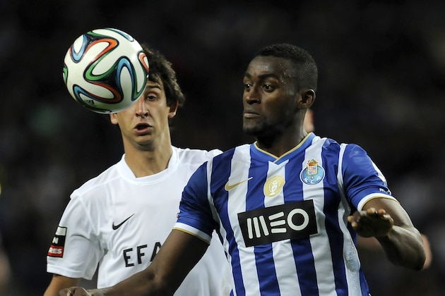 FC Porto's Jackson Martinez, from Colombia, eyes the ball past Academica's Paulo Grilo, left, in a Portuguese League soccer match at the Dragao stadium in Porto, Portugal, Sunday, April 6, 2014. Porto will play Sevilla in a Europa League Quarter-final, second leg soccer match on Tuesday, April 10. (AP Photo/Paulo Duarte)