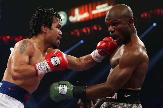 LAS VEGAS, NV - APRIL 12:  Manny Pacquiao throws a left hand at Timothy Bradley at the MGM Grand Garden Arena on April 12, 2014 in Las Vegas, Nevada.  (Photo by Jeff Gross/Getty Images)