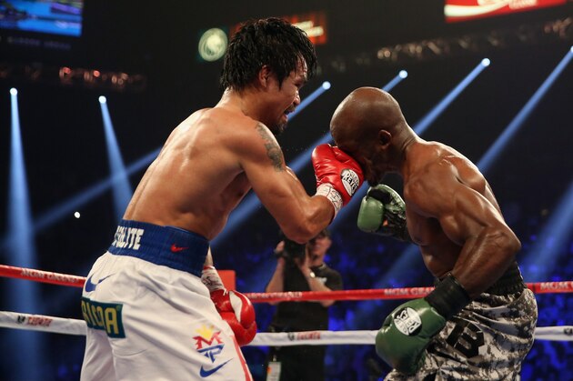 LAS VEGAS, NV - APRIL 12:  Manny Pacquiao lands a right hand to the head of Timothy Bradley at the MGM Grand Garden Arena on April 12, 2014 in Las Vegas, Nevada.  (Photo by Jeff Gross/Getty Images)