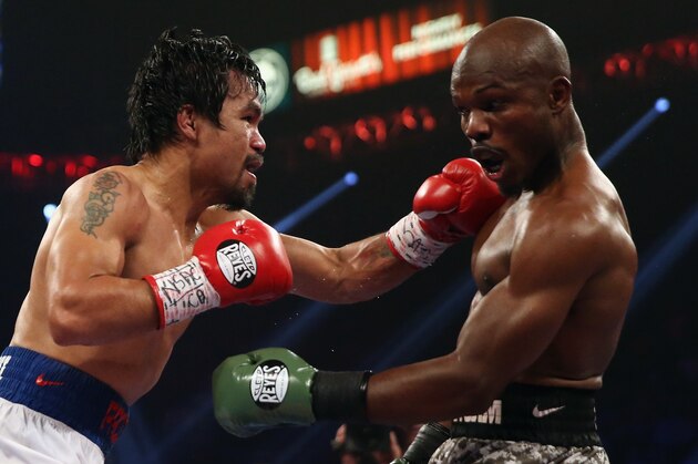 LAS VEGAS, NV - APRIL 12:  Manny Pacquiao throws a left hand at Timothy Bradley at the MGM Grand Garden Arena on April 12, 2014 in Las Vegas, Nevada.  (Photo by Jeff Gross/Getty Images)