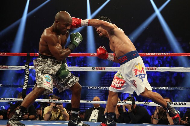 LAS VEGAS, NV - APRIL 12:  Manny Pacquiao throws a left hand at Timothy Bradley at the MGM Grand Garden Arena on April 12, 2014 in Las Vegas, Nevada.  (Photo by Jeff Gross/Getty Images)