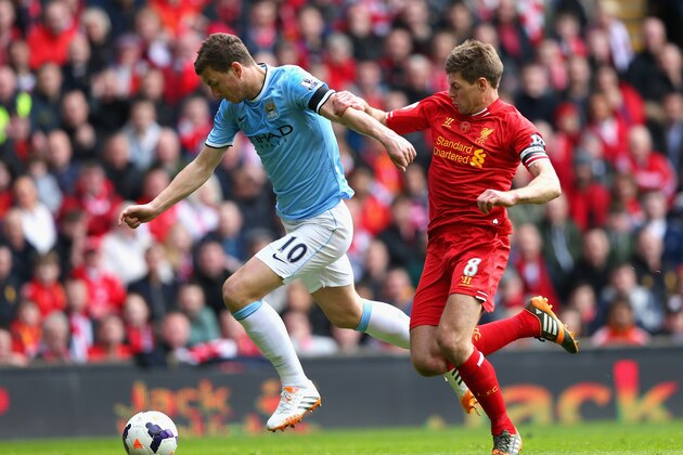 LIVERPOOL, ENGLAND - APRIL 13:  Steven Gerrard of Liverpool challenges Edin Dzeko of Manchester City during the Barclays Premier League match between Liverpool and Manchester City at Anfield on April 13, 2014 in Liverpool, England.  (Photo by Alex Livesey/Getty Images)