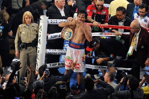 LAS VEGAS, NV - APRIL 12:  Manny Pacquiao celebrates after his unanimous decision victory over Timothy Bradley during their WBO world welterweight championship boxing match at the MGM Grand Garden Arena on April 12, 2014 in Las Vegas, Nevada.  (Photo by David Becker/Getty Images)