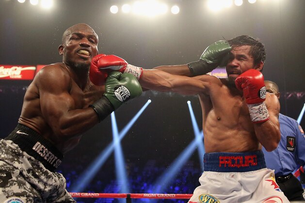 LAS VEGAS, NV - APRIL 12:  Timothy Bradley and Manny Pacquiao trade punches at the MGM Grand Garden Arena on April 12, 2014 in Las Vegas, Nevada.  (Photo by Jeff Gross/Getty Images)