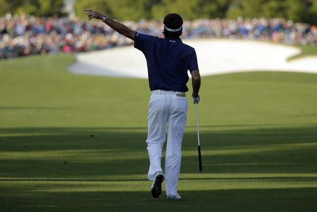 Bubba Watson points as his ball goes into the gallery on the 18th hole during the third round of the Masters golf tournament Saturday, April 12, 2014, in Augusta, Ga. (AP Photo/Chris Carlson)