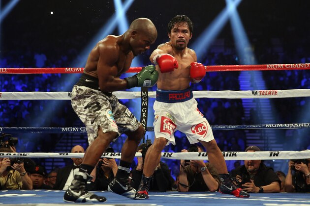 LAS VEGAS, NV - APRIL 12:  Manny Pacquiao throws a right hand at Timothy Bradley at the MGM Grand Garden Arena on April 12, 2014 in Las Vegas, Nevada.  (Photo by Jeff Gross/Getty Images)