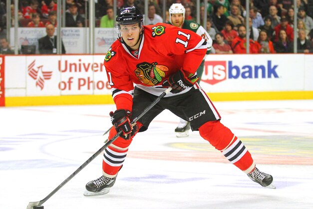 Apr 3, 2014; Chicago, IL, USA; Chicago Blackhawks left wing Jeremy Morin (11) skates with the puck during the second period against the Minnesota Wild at the United Center. Mandatory Credit: Dennis Wierzbicki-USA TODAY Sports