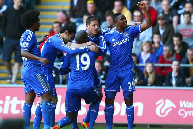 SWANSEA, WALES - APRIL 13:  Demba Ba #19 of Chelsea is congratulated by teammates after scoring the opening goal during the Barclays Premier League match between Swansea City and Chelsea at Liberty Stadium on April 13, 2014 in Swansea, Wales.  (Photo by Michael Steele/Getty Images)