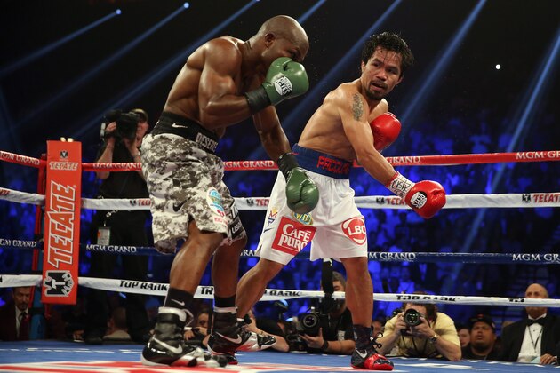 LAS VEGAS, NV - APRIL 12:  Manny Pacquiao follows through on a right hand to Timothy Bradley at the MGM Grand Garden Arena on April 12, 2014 in Las Vegas, Nevada.  (Photo by Jeff Gross/Getty Images)