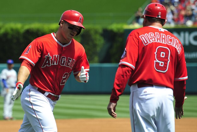 April 13, 2014; Anaheim, CA, USA; Los Angeles Angels center fielder Mike Trout (27) is congratulated by third base coach Gary DiSarcina (9) after hitting a solo home run in the first inning against the New York Mets at Angel Stadium of Anaheim. Mandatory Credit: Gary A. Vasquez-USA TODAY Sports