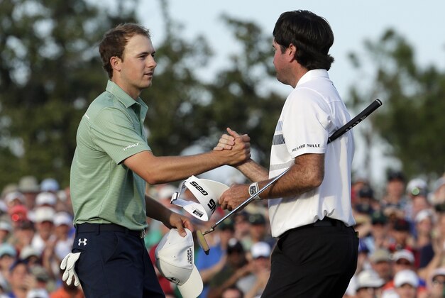 Bubba Watson, right, shakes hands with Jordan Spieth after winning the Masters golf tournament Sunday, April 13, 2014, in Augusta, Ga. (AP Photo/Charlie Riedel)