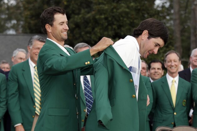 Defending Masters' champion Adam Scott, of Australia, helps Bubba Watson, right, with his green jacket after winning the Masters golf tournament Sunday, April 13, 2014, in Augusta, Ga. (AP Photo/Darron Cummings) Defending Masters' champion Adam Scott, of Australia, helps Bubba Watson, right, with his green jacket after winning the Masters golf tournament Sunday, April 13, 2014, in Augusta, Ga. (AP Photo/Darron Cummings)