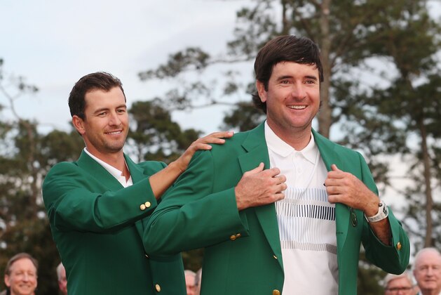 AUGUSTA, GA - APRIL 13:  Adam Scott of Australia presents Bubba Watson of the United States with the green jacket after Watson won the 2014 Masters Tournament by a three-stroke margin at Augusta National Golf Club on April 13, 2014 in Augusta, Georgia.  (Photo by Andrew Redington/Getty Images)