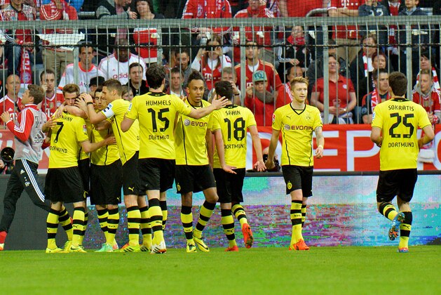 Dortmund's players celebrate after scoring during the  soccer match between FC Bayern Munich and Borussia Dortmund in Munich, Germany, on Saturday, April 12, 2014. (AP Photo/Kerstin Joensson)