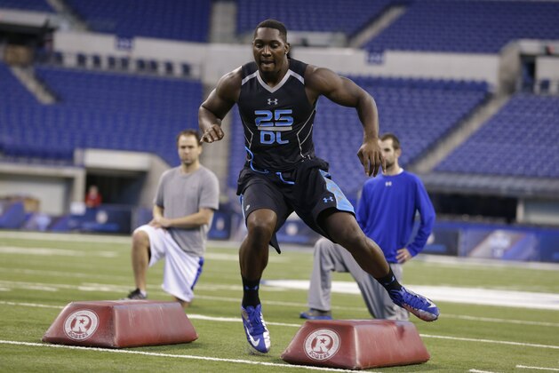 Boise State defensive lineman Demarcus Lawrence runs a drill at the NFL football scouting combine in Indianapolis, Monday, Feb. 24, 2014. (AP Photo/Michael Conroy)