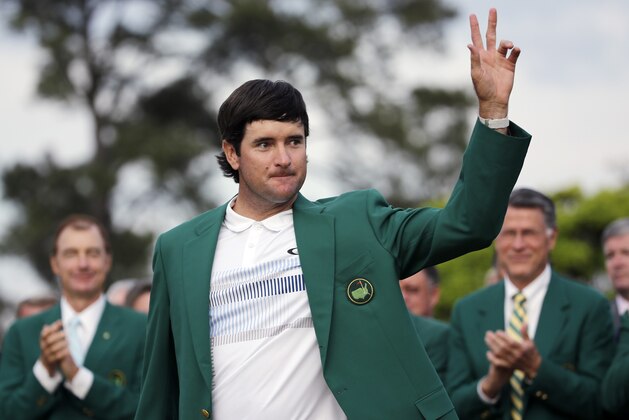 Bubba Watson waves after being presented with his green jacket after winning the Masters golf tournament Sunday, April 13, 2014, in Augusta, Ga.  (AP Photo/David J. Phillip)