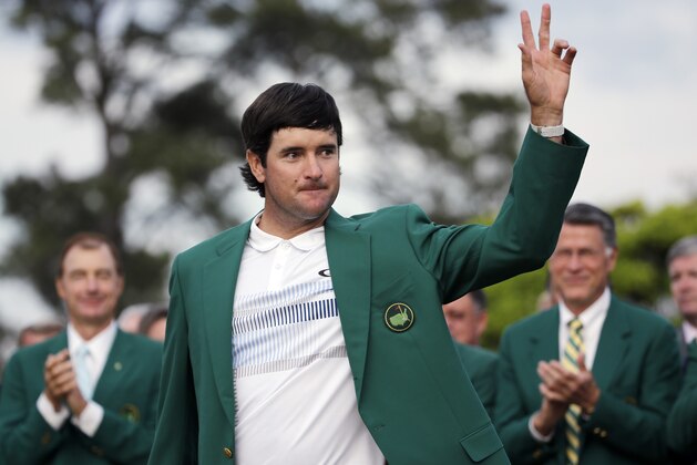 Bubba Watson waves after being presented with his green jacket after winning the Masters golf tournament Sunday, April 13, 2014, in Augusta, Ga.  (AP Photo/David J. Phillip)