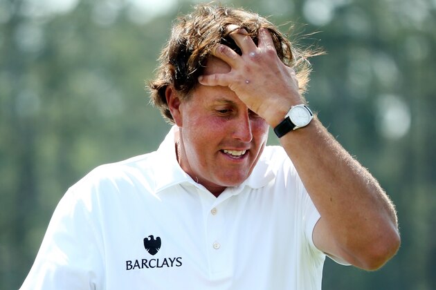 AUGUSTA, GA - APRIL 11:  Phil Mickelson of the United States walks off the 18th green after completing the second round of the 2014 Masters Tournament at Augusta National Golf Club on April 11, 2014 in Augusta, Georgia.  (Photo by Andrew Redington/Getty Images)