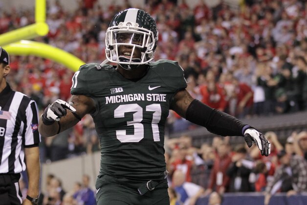 Michigan State's Darqueze Dennard (31) reacts during the second half of a Big Ten Conference championship NCAA college football game against Ohio State Saturday, Dec. 7, 2013, in Indianapolis. (AP Photo/AJ Mast)