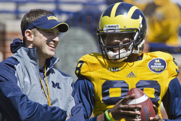 Michigan offensive coordinator Doug Nussmeier, left, laughs with quarterback Devin Gardner (98) during the NCAA college football team's annual spring game on Saturday, April 5, 2014, in Ann Arbor, Mich. (AP Photo/Tony Ding)