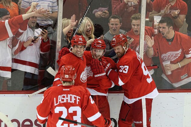 DETROIT, MI - APRIL 02:  Gustav Nyquist #14 of the Detroit Red Wings scores a third period game winning goal and is congratulated by his teammates during the game against the Boston Bruins at Joe Louis Arena on April 2, 2014 in Detroit, Michigan. The Red Wings defeated the Bruins 3-2  (Photo by Leon Halip/Getty Images)