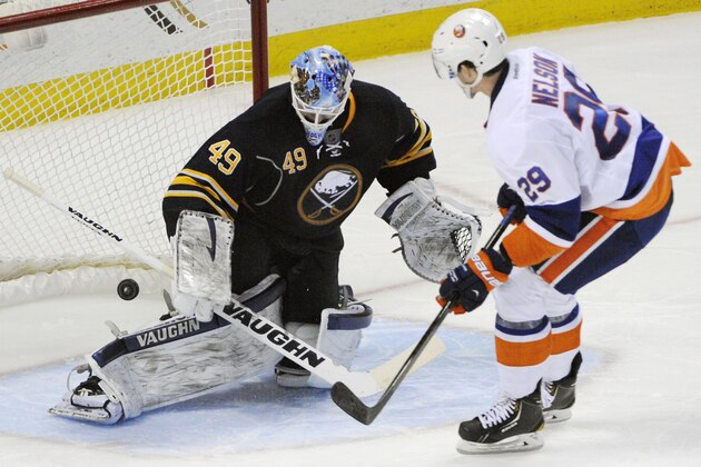 Buffalo Sabres goaltender Connor Knapp (49) gets beat as New York Islanders  center Brock Nelson (29) scores the game winning goal during the team shootout of an NHL hockey game in Buffalo, N.Y., Sunday April 13, 2014. New York won 4-3. (AP Photo/Gary Wiepert)