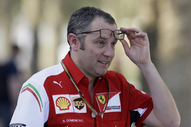 Ferrari team principal Stefano Domenicali maces his glasses in the paddock after the third practice session at the Formula One Bahrain International Circuit in Sakhir, Bahrain, Saturday, April 5, 2014. The Bahrain Formula One Grand Prix will take place here on Sunday. (AP Photo/Luca Bruno)