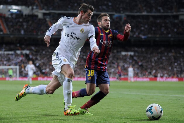 MADRID, SPAIN - MARCH 23:  Gareth Bale (L) of Real Madrid takes on Jordi Alba of Barcelona during the La Liga match between Real Madrid CF and FC Barcelona at the Bernabeu on March 23, 2014 in Madrid, Spain. (Photo by Denis Doyle/Getty Images)
