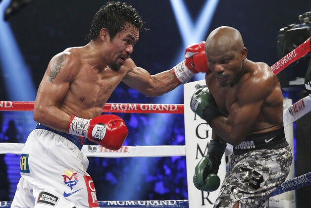 Manny Pacquiao, left, of the Philippines, drives Timothy Bradley into the ropes in their WBO welterweight title boxing bout Saturday, April 12, 2014, in Las Vegas. Pacquiao won by unanimous decision. (AP Photo/Isaac Brekken)