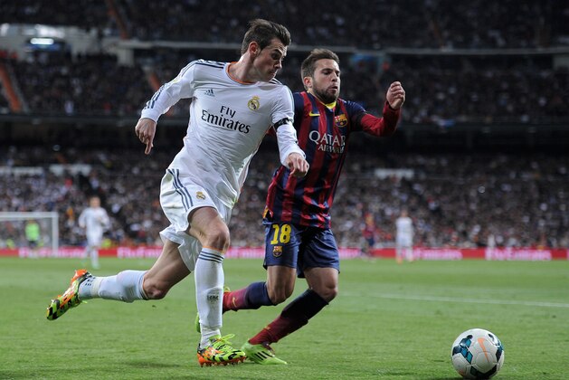 MADRID, SPAIN - MARCH 23:  Gareth Bale (L) of Real Madrid takes on Jordi Alba of Barcelona during the La Liga match between Real Madrid CF and FC Barcelona at the Bernabeu on March 23, 2014 in Madrid, Spain. (Photo by Denis Doyle/Getty Images)