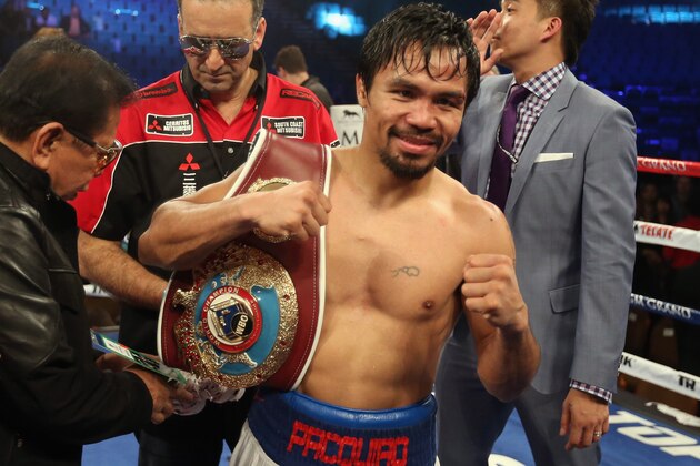 LAS VEGAS, NV - APRIL 12:  Manny Pacquiao celebrates his victory over Timothy Bradley at the MGM Grand Garden Arena on April 12, 2014 in Las Vegas, Nevada.  (Photo by Jeff Gross/Getty Images)
