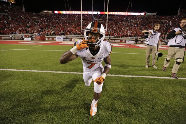 Oregon State wide receiver Brandin Cooks (7) takes a knee and blows a kiss after scoring the winning touch down in overtime during an NCAA college football game against Utah Saturday, Sept. 14, 2013, in Salt Lake City. Oregon State defeated Utah 51-48. (AP Photo/Rick Bowmer)