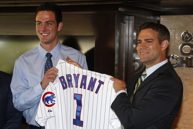 Chicago Cubs president of baseball operations Theo Epstein, right, poses with first-round draft pick, third baseman Kris Bryant during a news conference before a baseball game between the Chicago Cubs and the St. Louis Cardinals Friday, July 12 2013, in Chicago. (AP Photo/Charles Rex Arbogast)