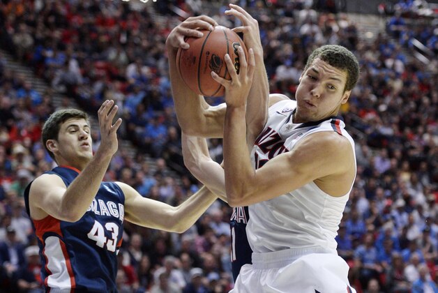 Mar 23, 2014; San Diego, CA, USA; Arizona Wildcats forward Aaron Gordon (right) pulls down a rebound against Gonzaga Bulldogs guard/forward Drew Barham (43) and guard David Stockton in the first half of a men's college basketball game during the third round of the 2014 NCAA Tournament at Viejas Arena. Mandatory Credit: Robert Hanashiro-USA TODAY Sports