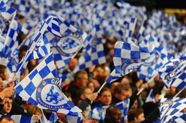 LONDON, ENGLAND - APRIL 08:  Chelsea fans wave flags during the UEFA Champions League Quarter Final second leg match between Chelsea and Paris Saint-Germain FC at Stamford Bridge on April 8, 2014 in London, England.  (Photo by Mike Hewitt/Getty Images)