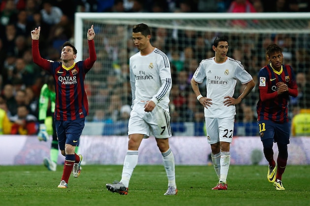 MADRID, SPAIN - MARCH 23:  Lionel Messi (L) of Barcelona celebrates scoring his team's third goal with Neymar (R) of Barcelona as Cristiano Ronaldo and Angel Di Maria of Real Madrid look dejected during the La Liga match between Real Madrid CF and FC Barcelona at the Bernabeu on March 23, 2014 in Madrid, Spain.  (Photo by Gonzalo Arroyo Moreno/Getty Images)