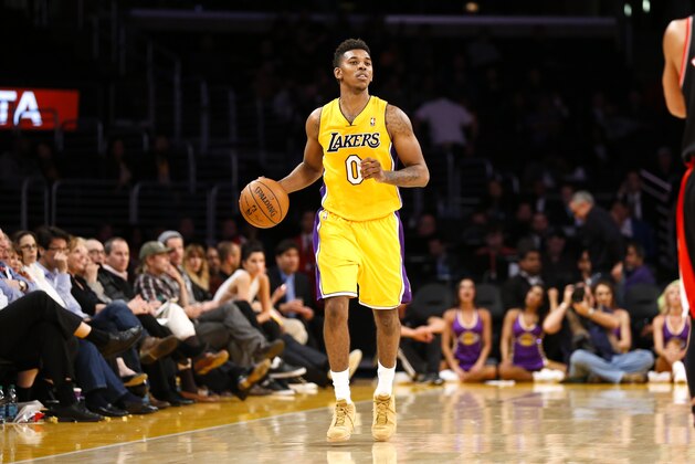Los Angeles Lakers forward Nick Young dribbles the ball against the Portland Trail Blazers during the second half of an NBA basketball game in Los Angeles, Tuesday, April 1, 2014. The Trail Blazers won 124-112. (AP Photo/Danny Moloshok)