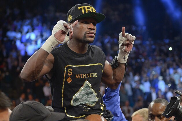 Floyd Mayweather Jr. celebrates after defeating Canelo Alvarez during a 152-pound title fight, Saturday, Sept. 14, 2013, in Las Vegas. (AP Photo/Mark J. Terrill)