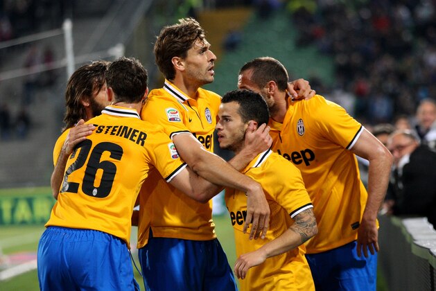 UDINE, ITALY - APRIL 14:  Sebastian Giovinco of Juventus is mobbed by team mates after scoring his team's opening goal during the Serie A match between Udinese Calcio and Juventus at Stadio Friuli on April 14, 2014 in Udine, Italy.  (Photo by Dino Panato/Getty Images)