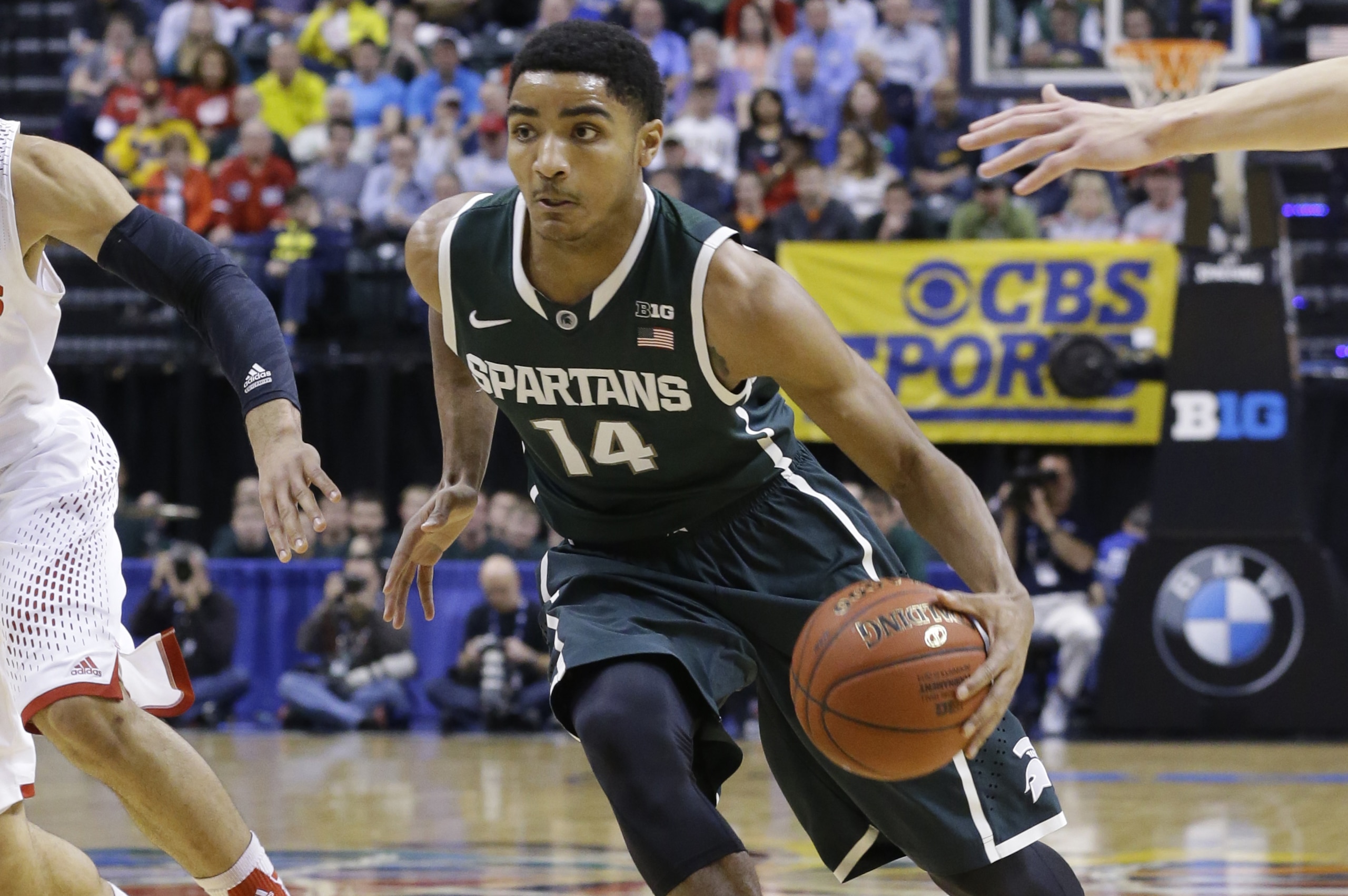 Michigan State guard Gary Harris drives the ball in the first half of an NCAA college basketball game against Wisconsin in the semifinals of the Big Ten Conference tournament Saturday, March 15, 2014, in Indianapolis. (AP Photo/Michael Conroy)