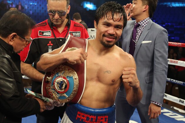 LAS VEGAS, NV - APRIL 12:  Manny Pacquiao celebrates his victory over Timothy Bradley at the MGM Grand Garden Arena on April 12, 2014 in Las Vegas, Nevada.  (Photo by Jeff Gross/Getty Images)