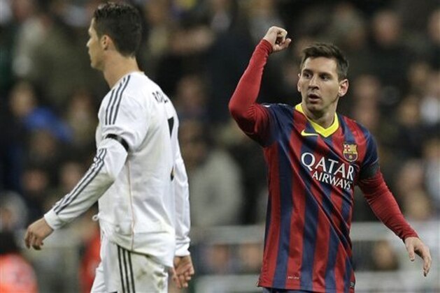 FC Barcelona's Lionel Messi from Argentina, right celebrates next to Real Madrid's Cristiano Ronaldo after scoring his team's 2nd goal during a Spanish La Liga soccer match at the Santiago Bernabeu stadium in Madrid, Sunday March 23, 2014. (AP Photo/Paul White)