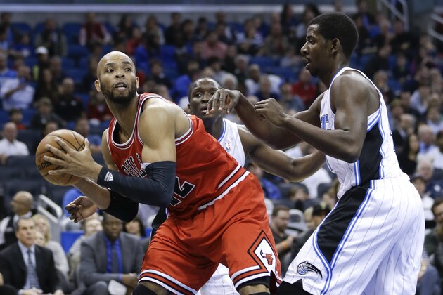 Chicago Bulls' Taj Gibson, left, looks to pass as he is guarded by Orlando Magic's Andrew Nicholson during the first half of an NBA basketball game in Orlando, Fla., Wednesday, Jan. 15, 2014.(AP Photo/John Raoux)