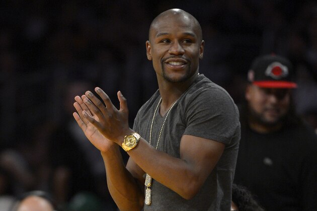 Boxer Floyd Mayweather watches the Los Angeles Lakers play the Boston Celtics during the second half of an NBA basketball game, Friday, Feb. 21, 2014, in Los Angeles. (AP Photo/Mark J. Terrill)