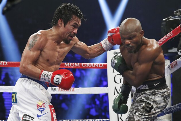 Manny Pacquiao, left, of the Philippines, drives Timothy Bradley into the ropes in their WBO welterweight title boxing bout Saturday, April 12, 2014, in Las Vegas. Pacquiao won by unanimous decision. (AP Photo/Isaac Brekken)