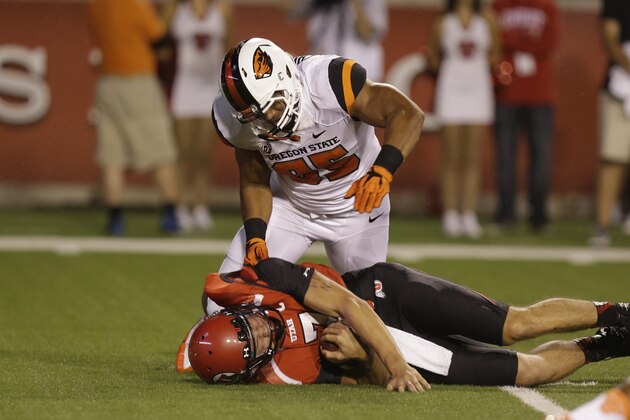 Utah quarterback Travis Wilson, below, is sacked by Oregon State defensive end Scott Crichton (95) in the first quarter during an NCAA college football game Saturday, Sept. 14, 2013, in Salt Lake City. (AP Photo/Rick Bowmer)