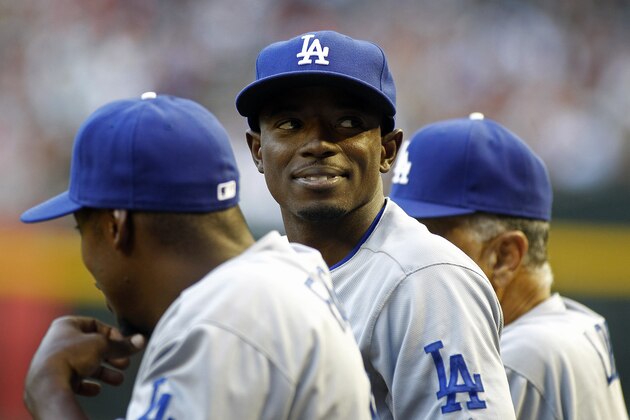 Los Angeles Dodgers' Dee Gordon, center, looks on from the dugout during the third inning of a baseball game against the Arizona Diamondbacks on Saturday, April 12, 2014, in Phoenix. The Dodgers defeated the Diamondbacks 8-5. (AP Photo/Ralph Freso)