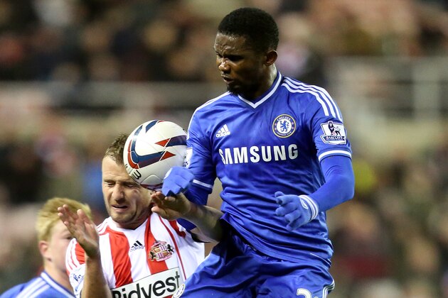 Chelsea's Samuel Eto'o, right, vies for the ball with Sunderland's Lee Cattermole, left, during their English League Cup quarter final soccer match at the Stadium of Light, Sunderland, England, Tuesday, Dec. 17, 2013. (AP Photo/Scott Heppell)