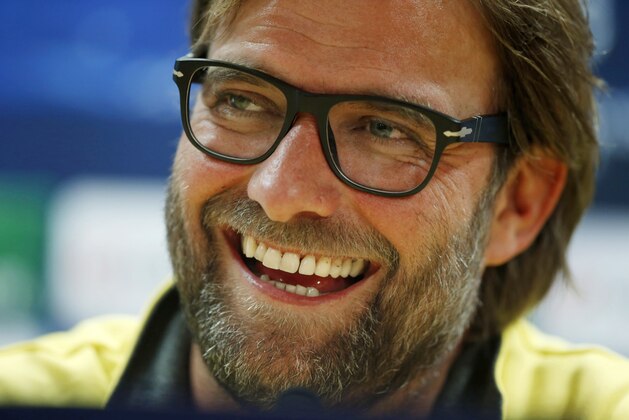 Borussia Dortmund's manager Jurgen Klopp laughs during a news conference at Arsenal's Emirates Stadium in London, England, Monday, Oct. 21, 2013. Arsenal are due to play Borussia Dortmund in a Champions League Group F soccer match in London on Tuesday. (AP Photo/Matt Dunham)